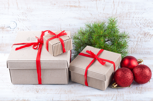 Christmas handmade gift boxes with raffia ribbons, Christmas ornaments and  a branch of pine Stock Photo by LanaSweet