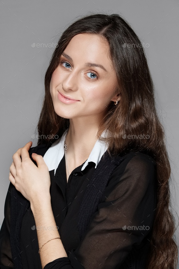 Portrait of a girl with natural make up in black blouse with white collar