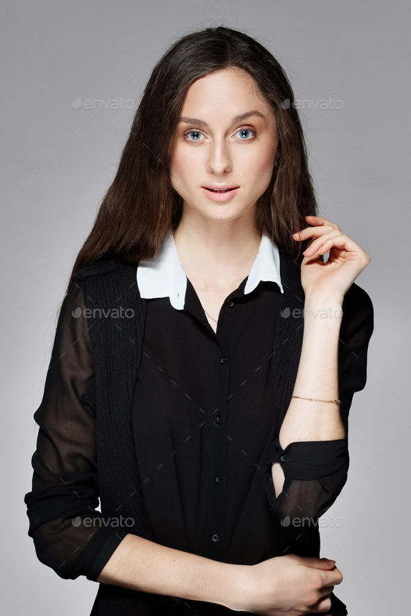 Portrait of a girl with natural make up in black blouse with white collar