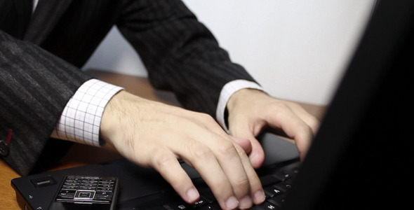 Businessman Typing On Laptop Keyboard