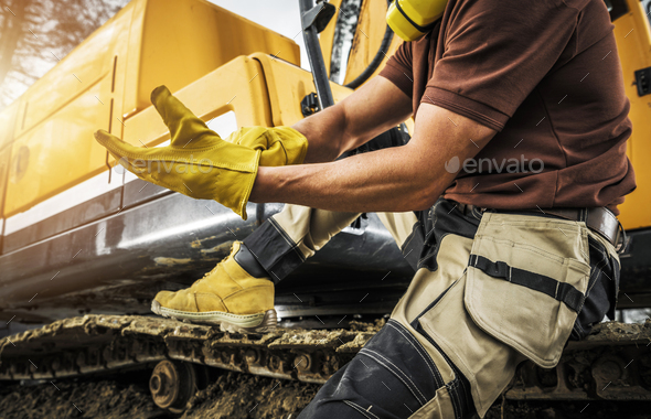 Heavy Construction Equipment Operator Wearing Safety Gloves