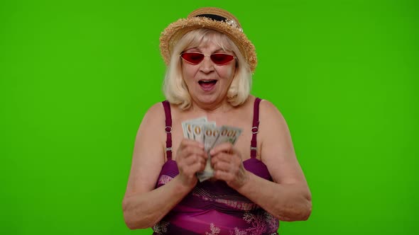 Mature Woman Traveler Tourist Takes Money Out of Swimsuit Bra Counting Bunch of Dollars Cash alt