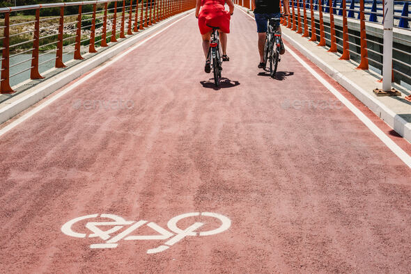 Bicycle lane with signal on the ground and cyclists passing over