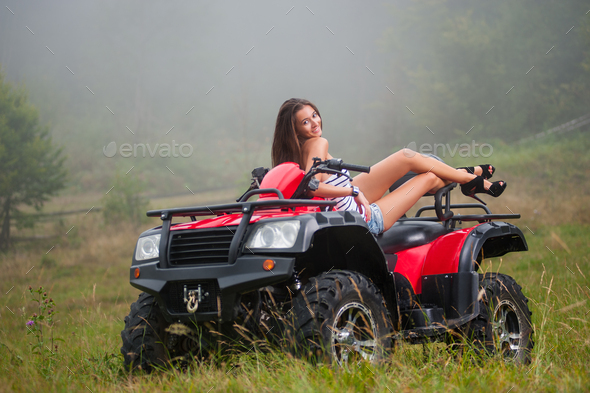 Beautiful girl on four-wheeler ATV