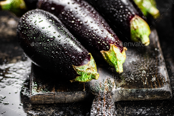 Ripe eggplant with droplets of water.