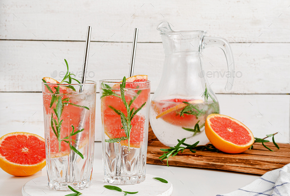 Refreshing infused water for slimming treatment with grapefruit and rosemary. Dieting concept