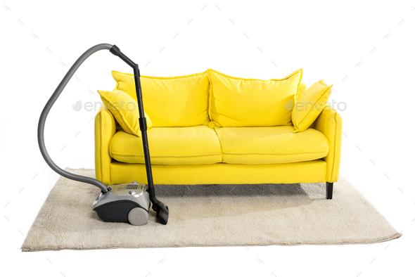 bright yellow sofa and vacuum cleaner on carpet isolated on white