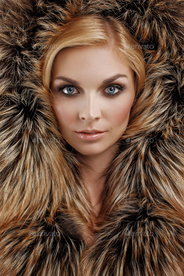 Attractive lady in black fur coat and hat. Perfect makeup, red mat lips