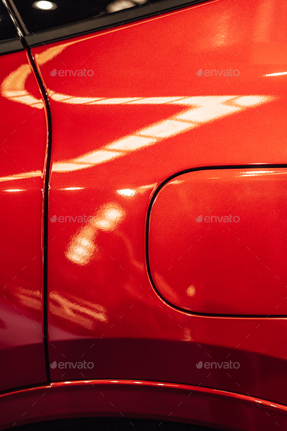 Detail of the fuel tank entry on a red car