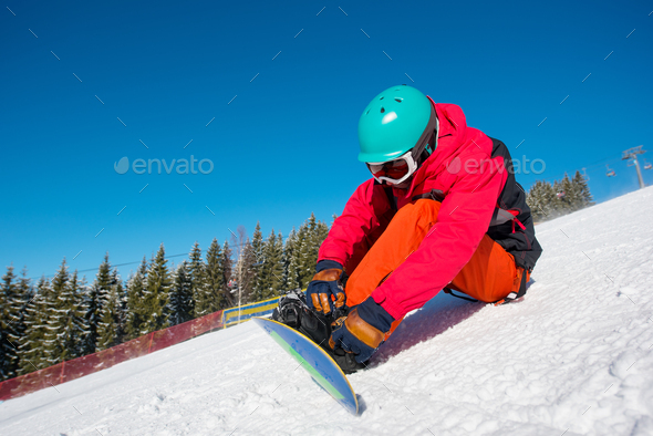 Snowboarder resting in the mountains
