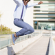 Cheerful black man riding skateboard and jumping - PhotoDune Item for Sale