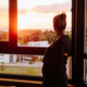 Pregnant woman contemplating the sunset from the window - PhotoDune Item for Sale