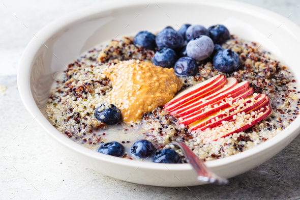 Quinoa porridge with apple, blueberry, peanut butter and hemp seeds