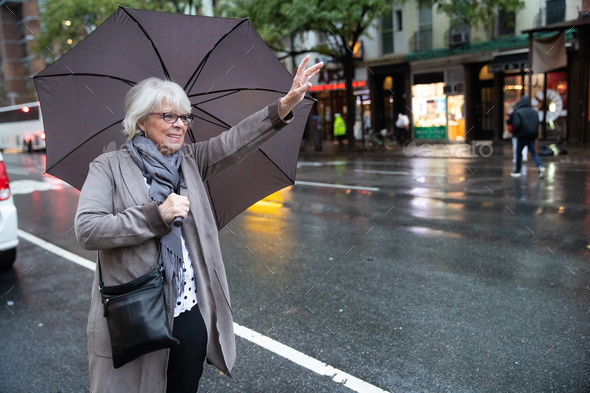 Mature senior white haired woman waiting for taxi cab in New York Stock ...