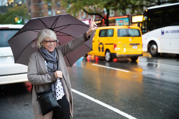 Mature senior white haired woman waiting for taxi cab in New York Stock ...