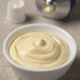 Bowl with Mayonnaise and a tube of mayonnaise in the background - PhotoDune Item for Sale