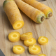 Yellow carrots and slices on a cutting board - PhotoDune Item for Sale