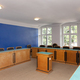 Meeting room, with desks and chair and central podium, old fashioned decor, bright blue walls - PhotoDune Item for Sale