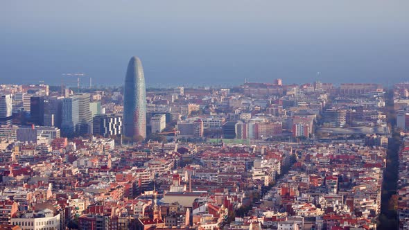 Panning shot high angle of Barcelona city on sunny day overlooking the sea alt