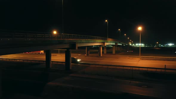 Multi Lane Highway with Bridges and Car Traffic at Night alt