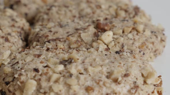 Slow tilt over orasnice walnut cookies on pile 4K video alt