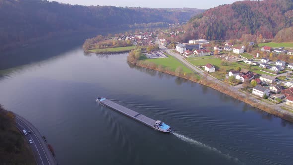 Cargo Pusher Boat on a River Transporting Cargo and Goods Along a River Bend alt