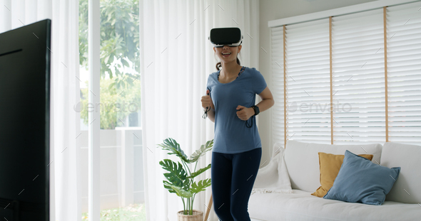 Asia people beautiful young woman wear smart VR goggles enjoy workout