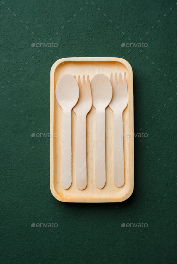 Plastic free set bamboo spoon and fork on dark green background.Zero waste disposable kitchen ware