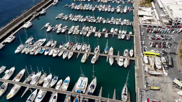 Aerial footage of the beautiful Boats a Boat Harbour Marina and pier taken in Lanzarote