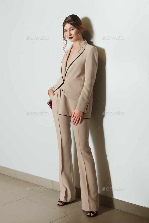 Attractive model in beige jacket and trousers suite