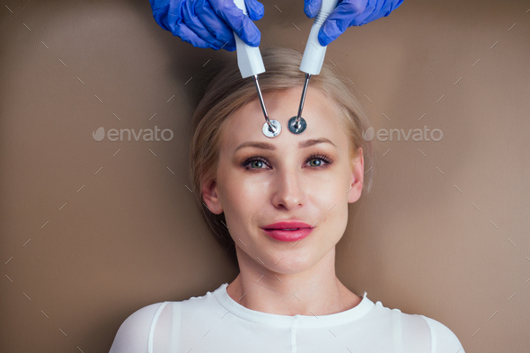 beauty aesthetic spa salon .blonde female getting instrument facial massaging