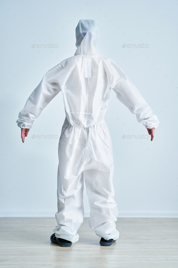Woman in bio-hazard suit on white background.
