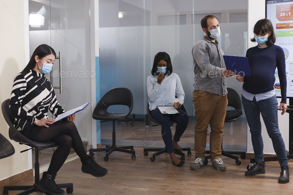 HR department pregnant manager wearing protective mask talking with man