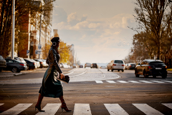 Young woman crossing the street - Stock Photo - Images