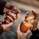 Close-up of couple&#39;s hands with croissant - PhotoDune Item for Sale