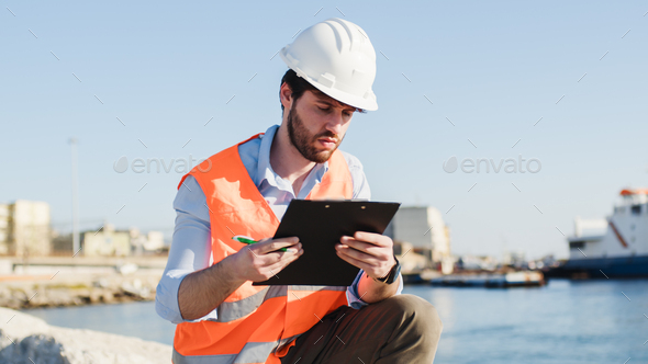Naval engineer quality check in the port in a city near the ocean - Stock Photo - Images