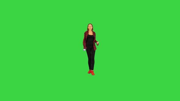 Young Girl Dances in Front of Camera on a Green Screen Chroma Key