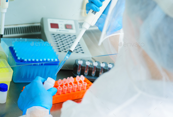 PCR lab worker creates a vaccine against covid-19 coronavirus infection.