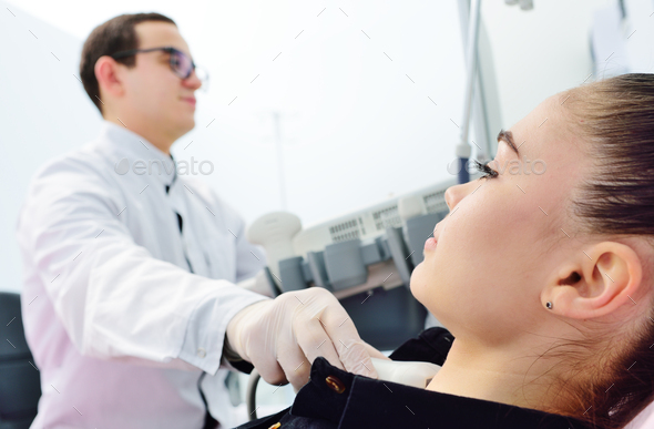 doctor checks the thyroid gland patient an ultrasound machine