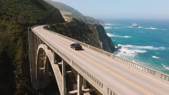 Electric Car Driving By Scenic Bridge Cinematic Ocean Background Ecology Shot alt
