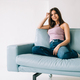 Young calm caucasian woman relaxing, sitting on sofa in modern living room - PhotoDune Item for Sale