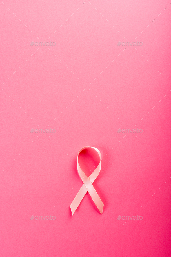 Overhead view of pink breast cancer awareness ribbon isolated