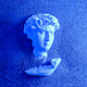 Bust head of David plaster antique in the sand on the beach. - PhotoDune Item for Sale