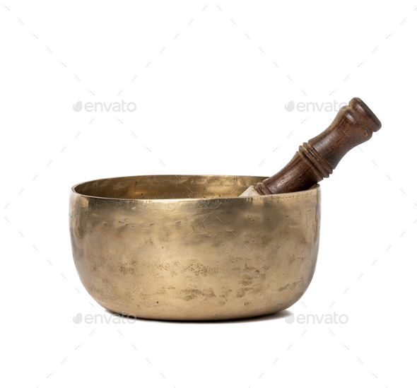 Copper singing bowl and wooden mallet isolated on white background