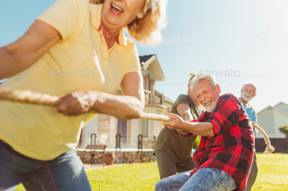 Elderly people playing tug of war