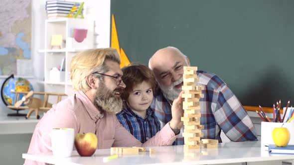Three Generations of Men Having Fun Together. Grandfather, Father Teaching Grandson How To Play alt