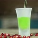 in the ice glass standing on the table poured green alcoholic beverage. - VideoHive Item for Sale