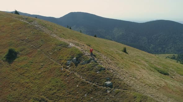 Lonely Hiker Walking on Mountain Trail. Trekking Adventure Concept, Survival Concept alt