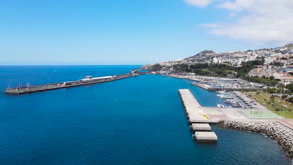 Drone aerial pan right view of Atlantic Ocean and the harbor in Funchal city, Madeira island in Port alt