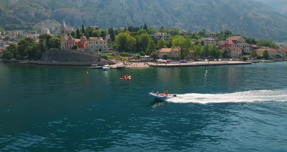 speeding boat with  St. Matthias Church  in kotor bay on the background alt